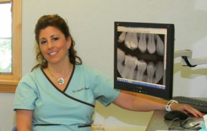 staff member sitting in front of computer screen with digital x-ray