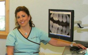 staff member sitting in front of computer screen with digital x-ray